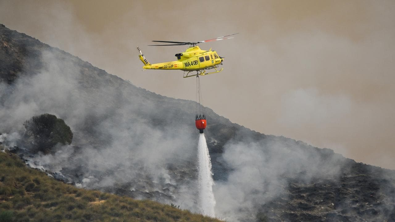 Helicopter drops water on a wildfire in Almeria, southern Spain