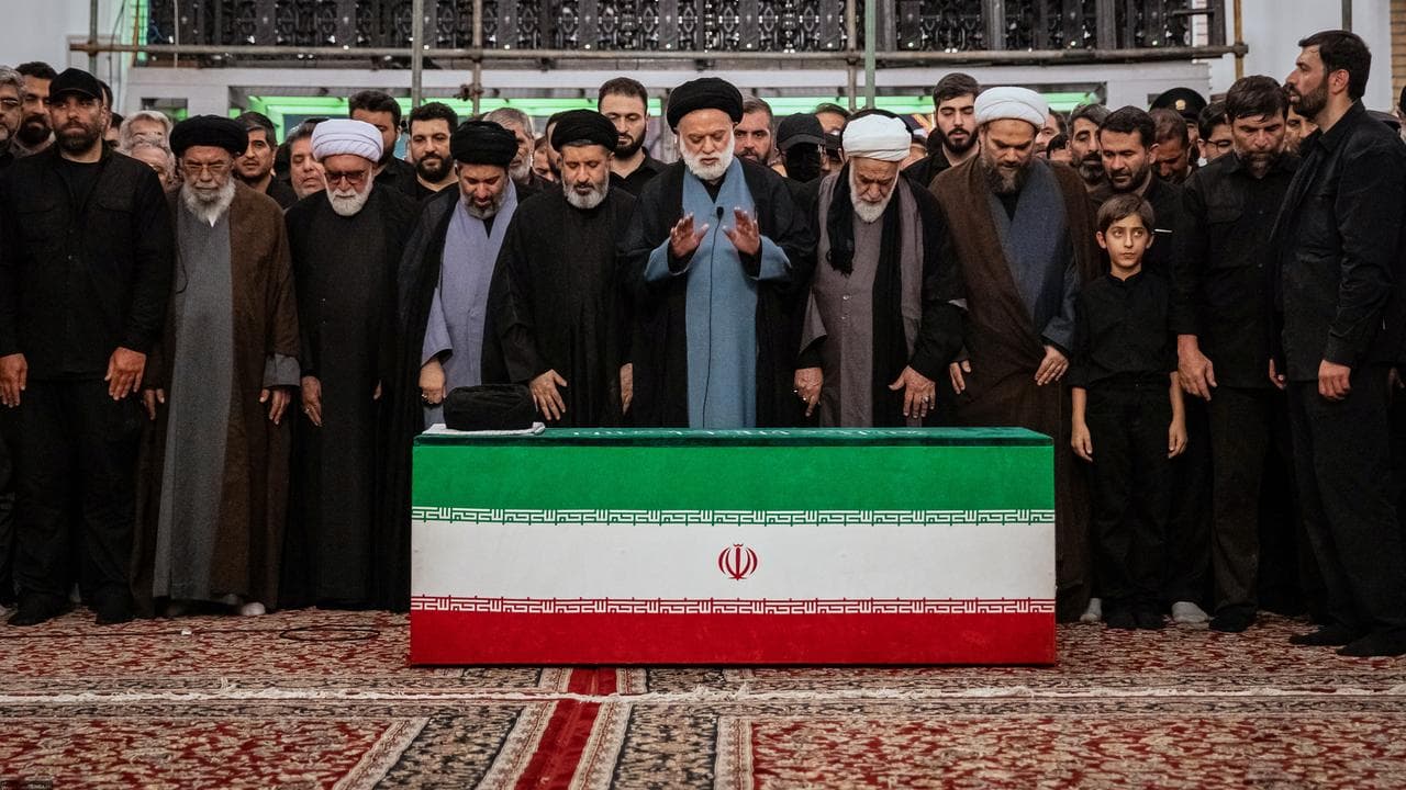 The coffin of Iran's late Supreme Leader Ali Khamenei with relatives