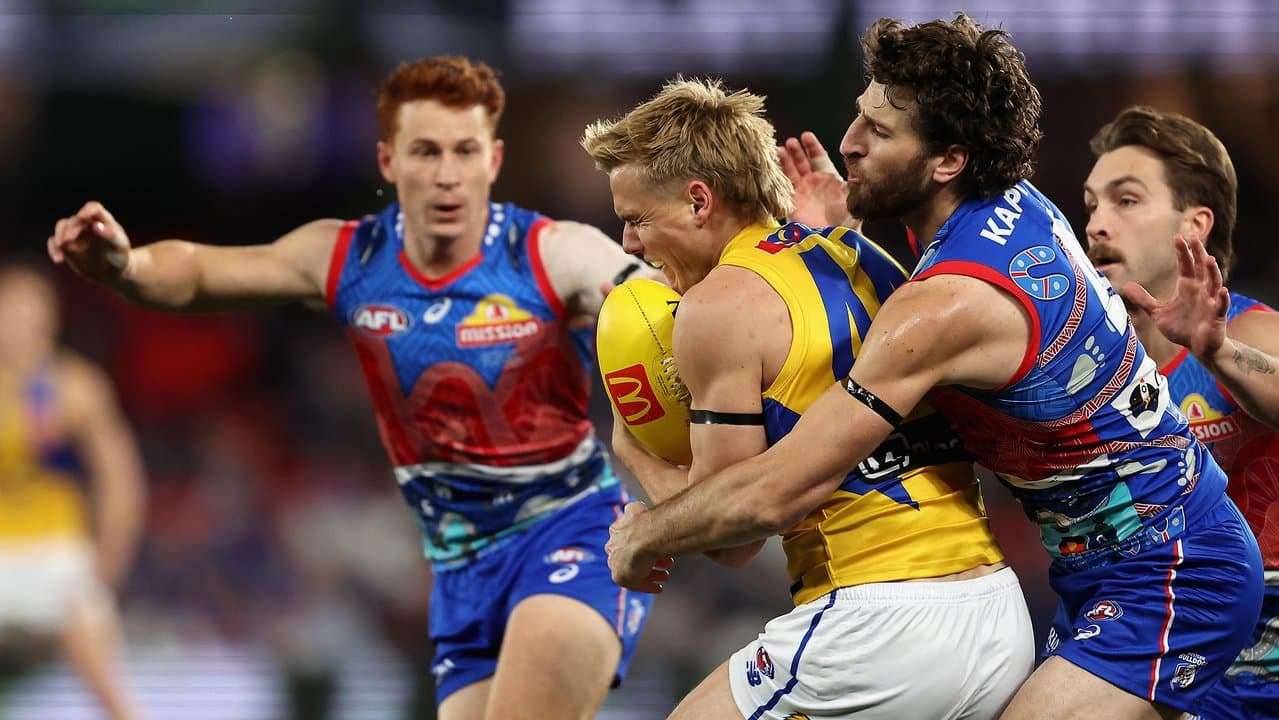 Marcus Bontempelli tackles the Eagles' Jack Hutchinson.