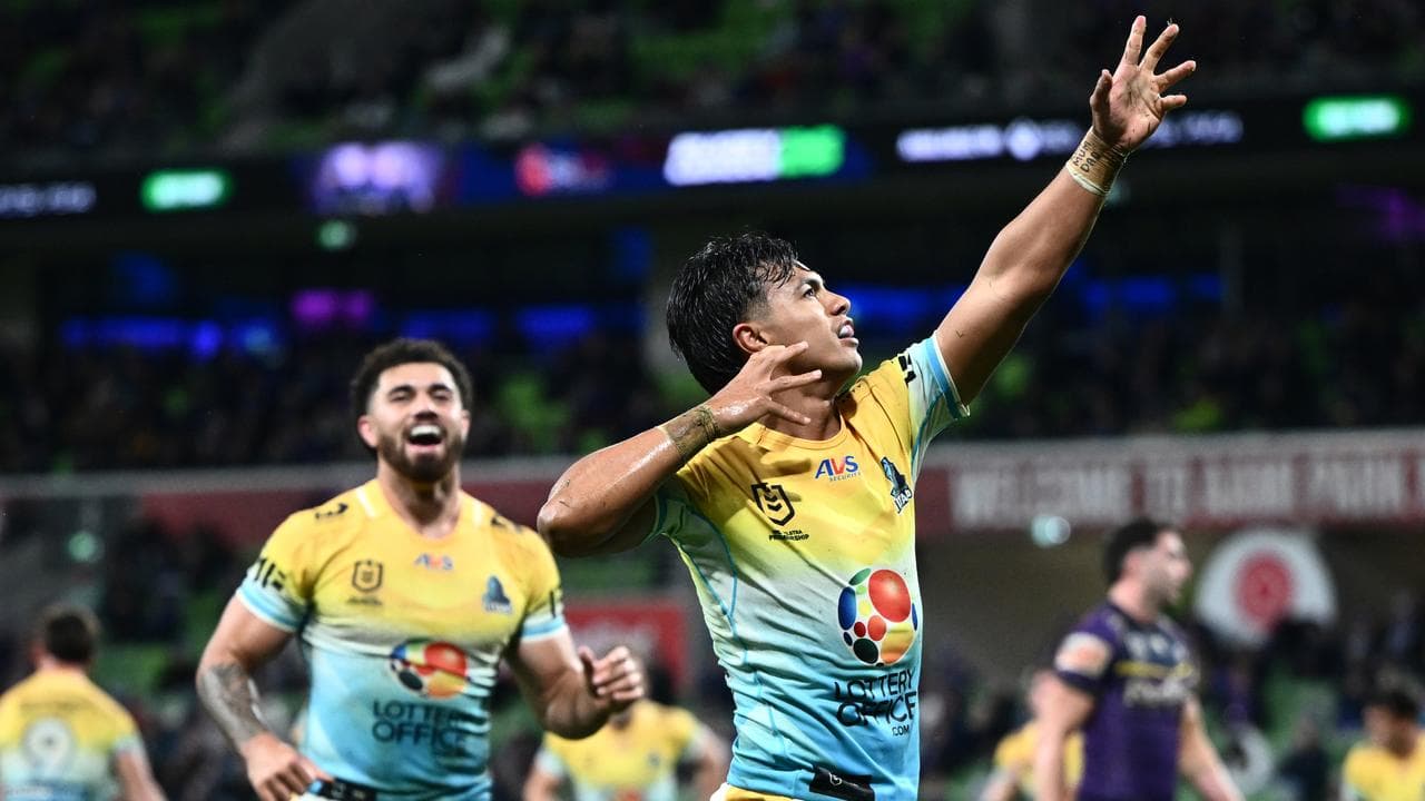 Keano Kini of the Titans celebrates scoring a try
