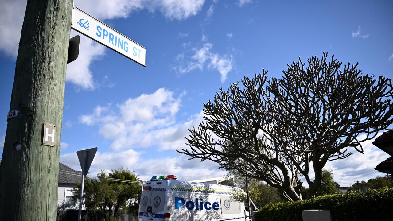 street sign in foreground, police van in background