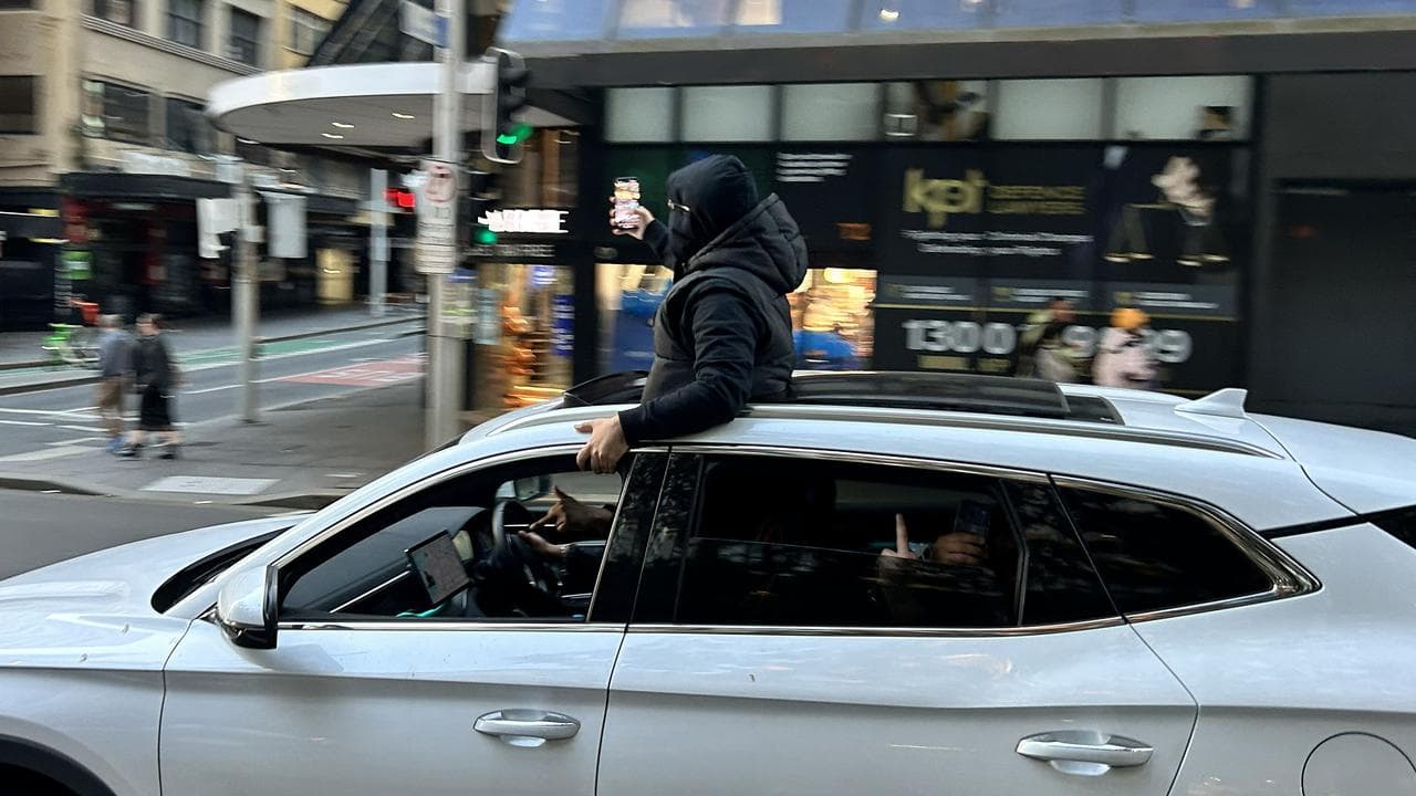 man's upper body out of the sunroof