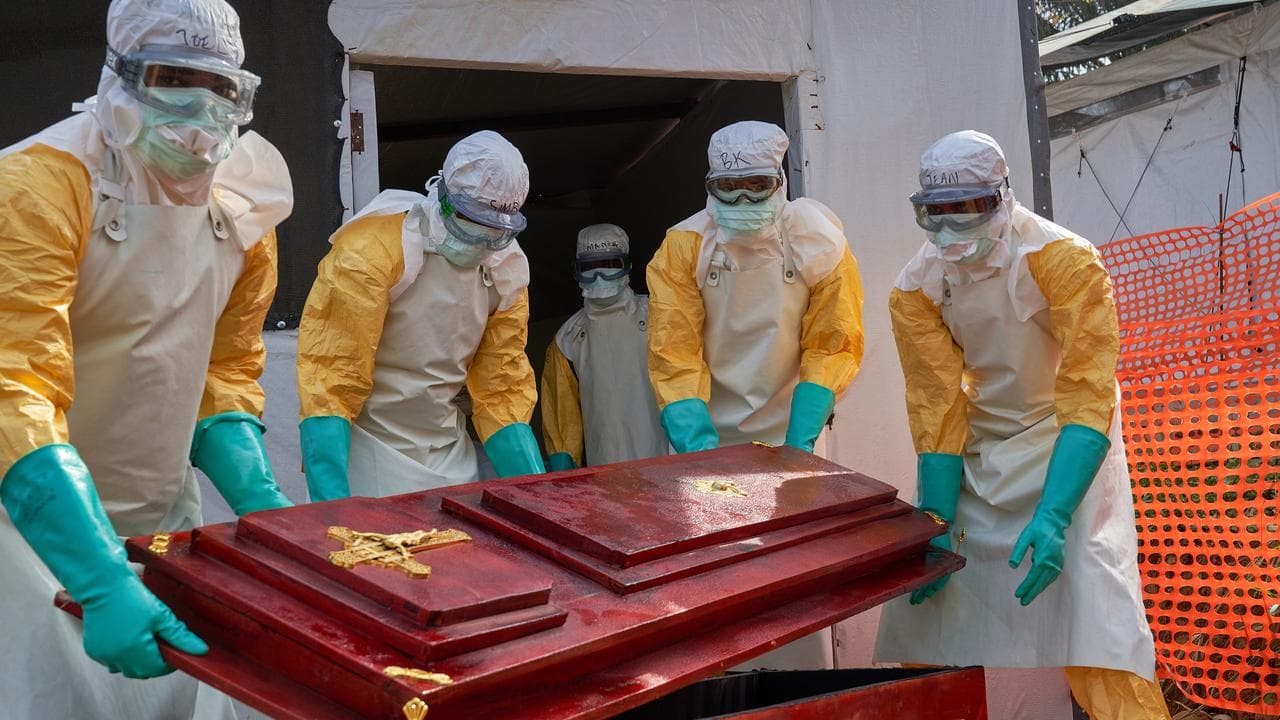 Staff carry a coffin for an Ebola victim at the hospital in Mongbwalu