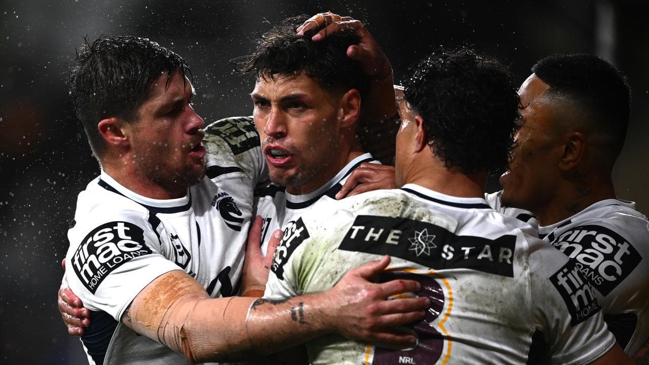 Jordan Riki of the Broncos (second left) celebrates with teammates