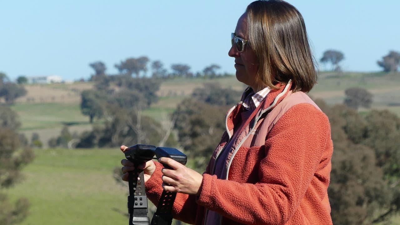 Farmer Anna Shaw holds a Halter virtual fencing collar
