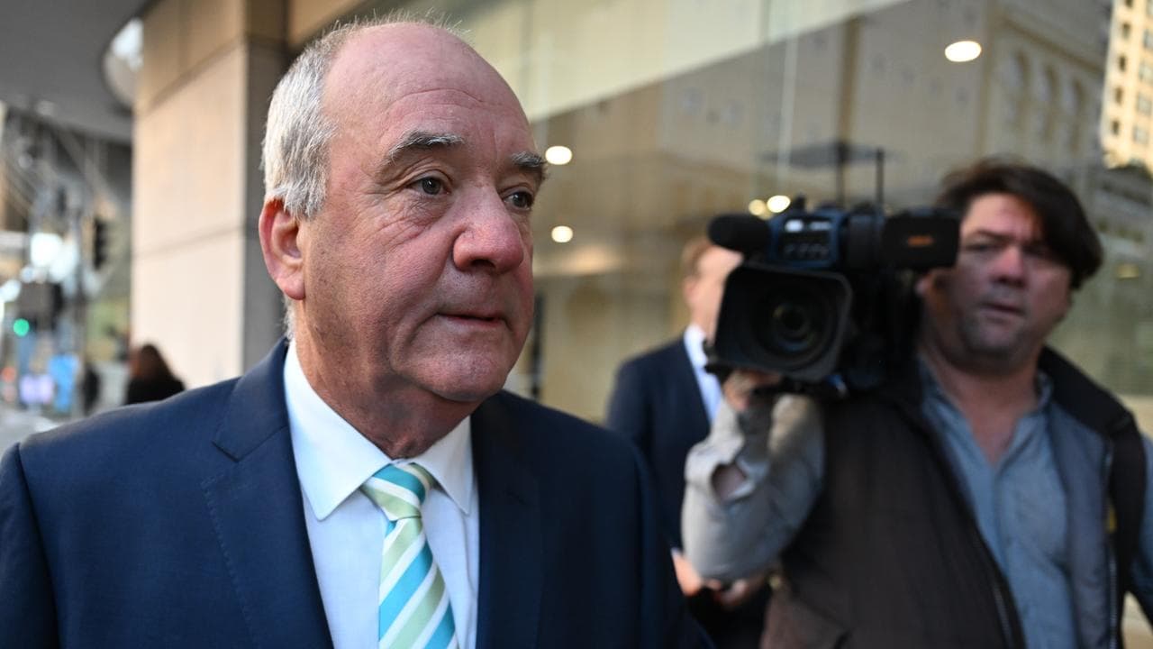 daryl maguire walks near TV camera