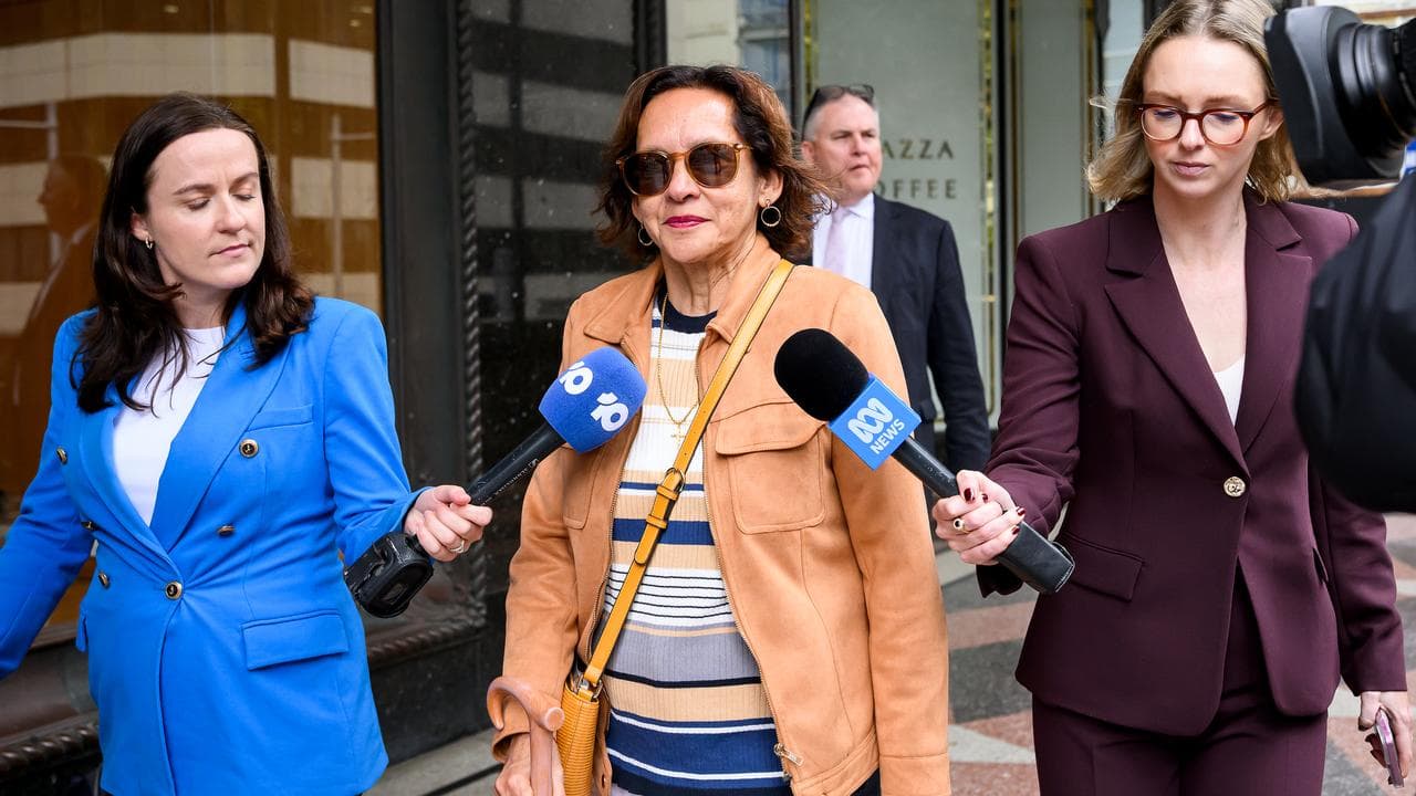 woman leaves court with TV reporters in tow