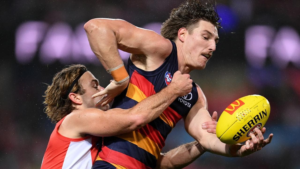 James Rowbottom of the Swans tackles Josh Worrell of the Crows