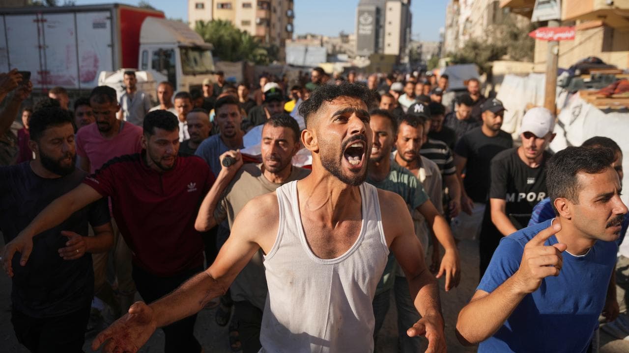 Mourners carry the body of a man who was killed in an Israeli strike