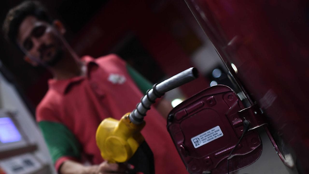 People refuel their vehicles at a gas station in Karachi, Pakistan