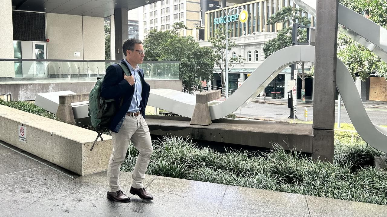 man with backpack leaves court
