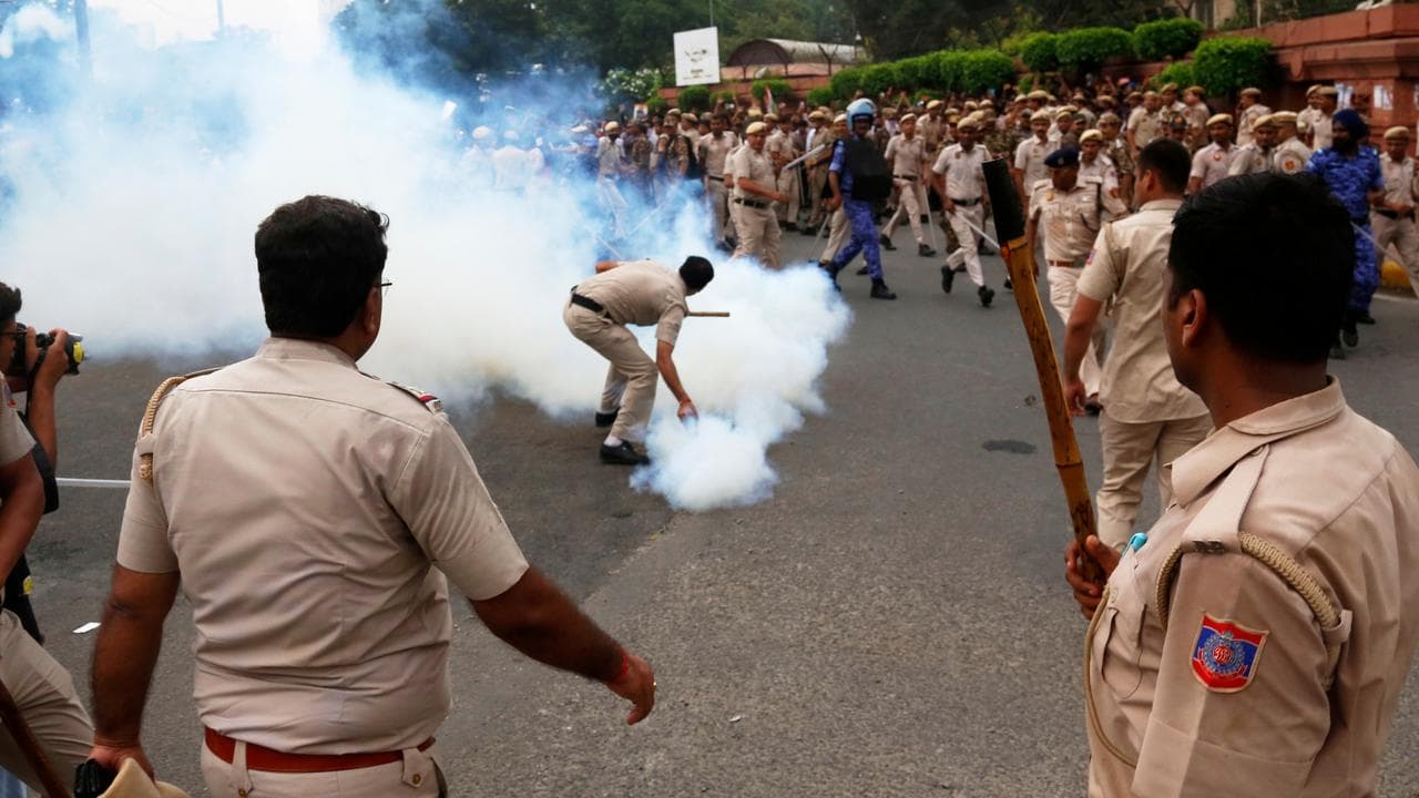 Security officers use tear gas to disperse Cockroach party supporters