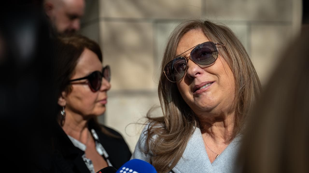 woman speaks to reporters