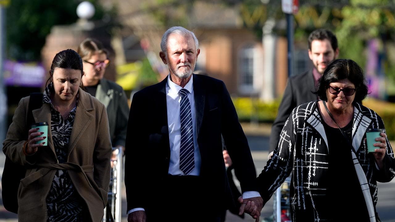 Neil Morrison holds hand with woman
