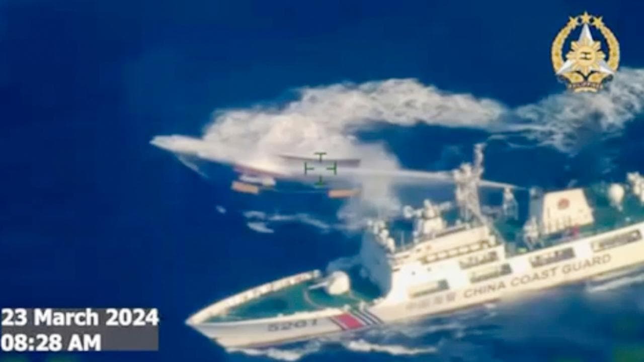 A Chinese coast guard ship uses water cannon on a Philippine vessel