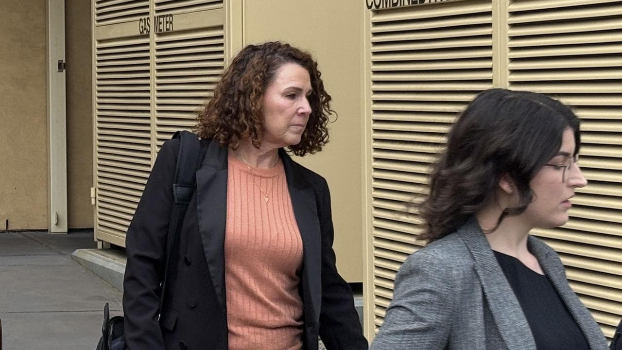 woman walks from court