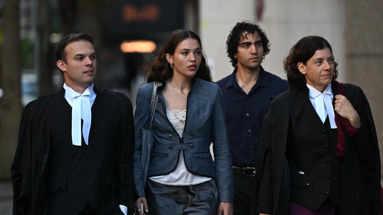 Charlotte MacInnes flanked by legal team