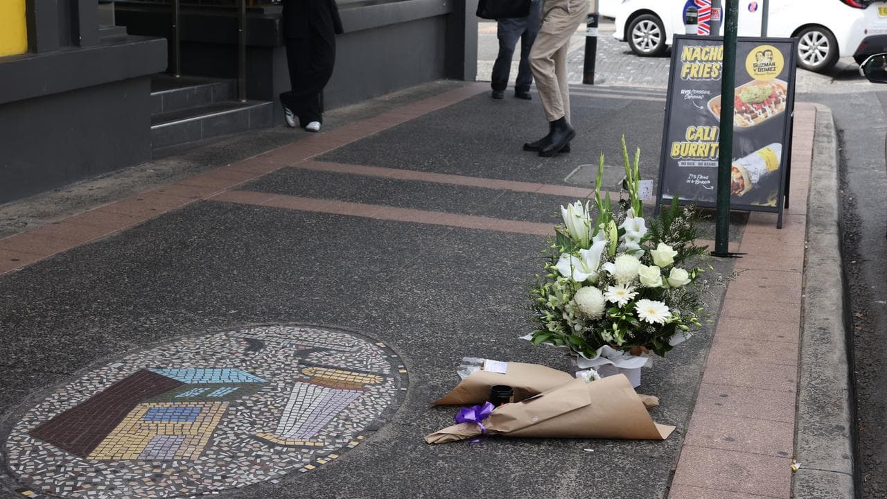 floral tribute on footpath
