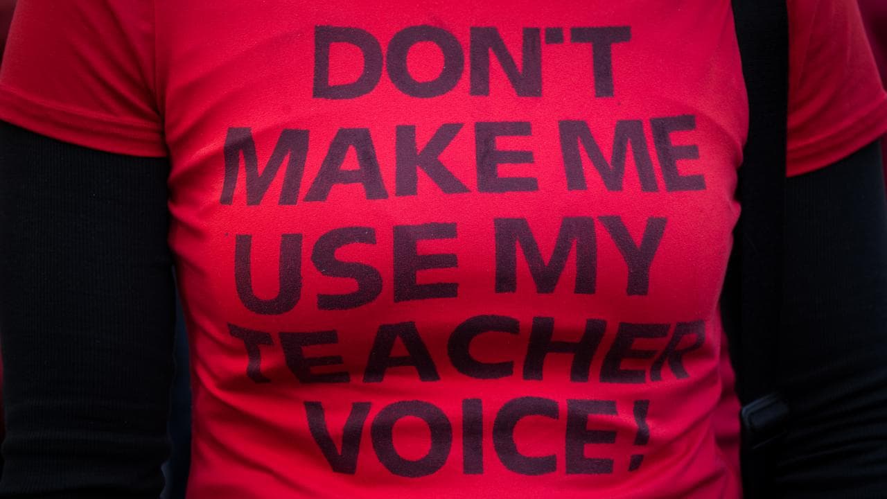 A teacher wearing a T-shirt at the rally