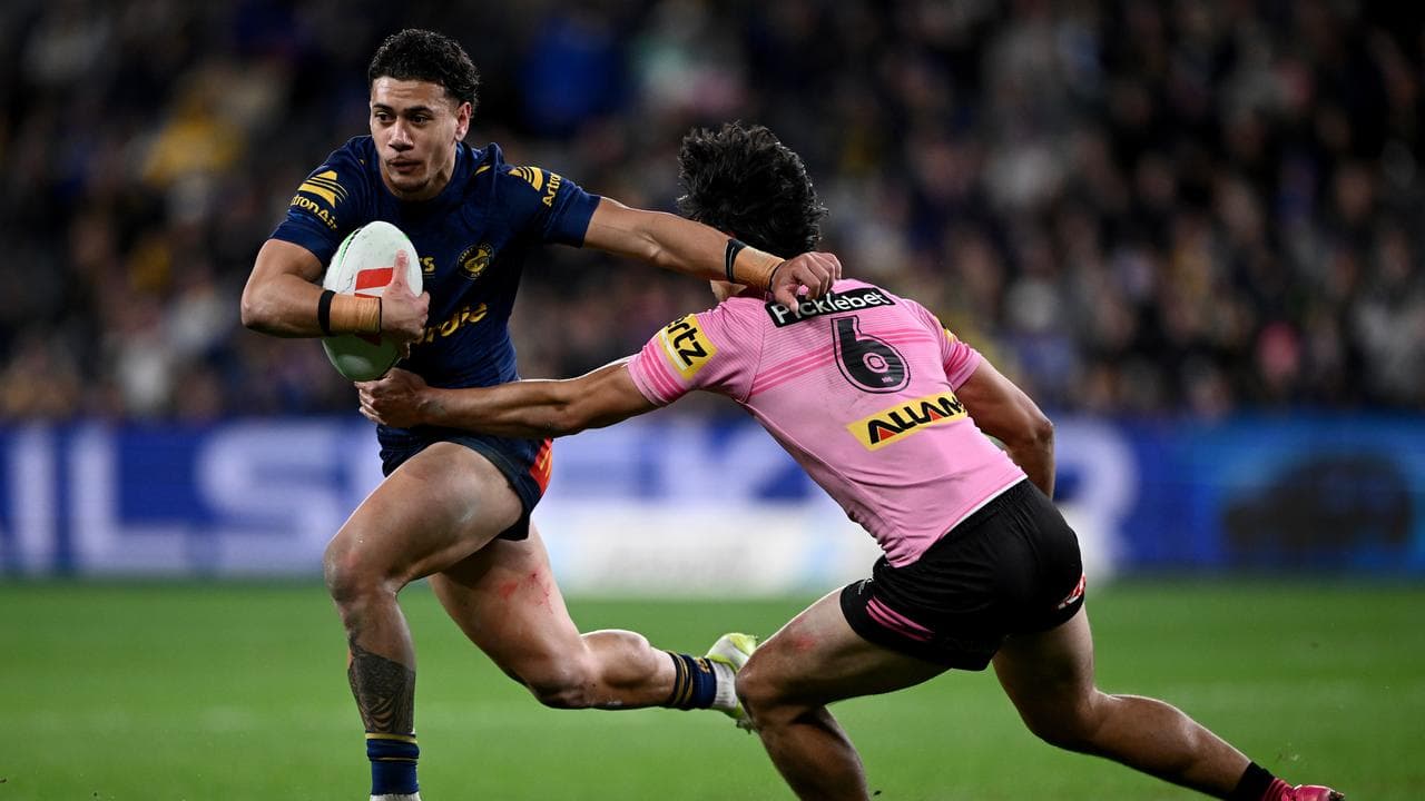 Isaiah Iongi of the Eels is tackled by Blaize Talagi