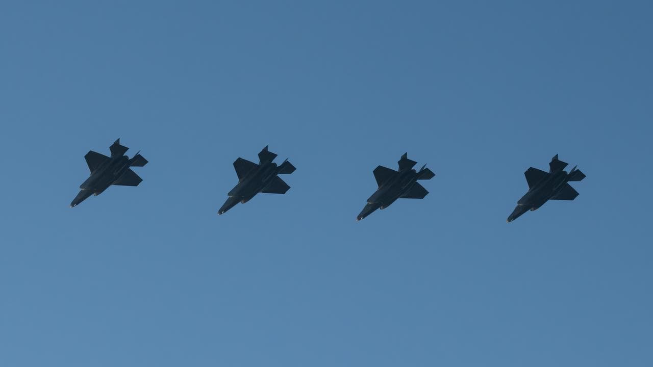 Four F-35A Lightning II aircraft fly in formation