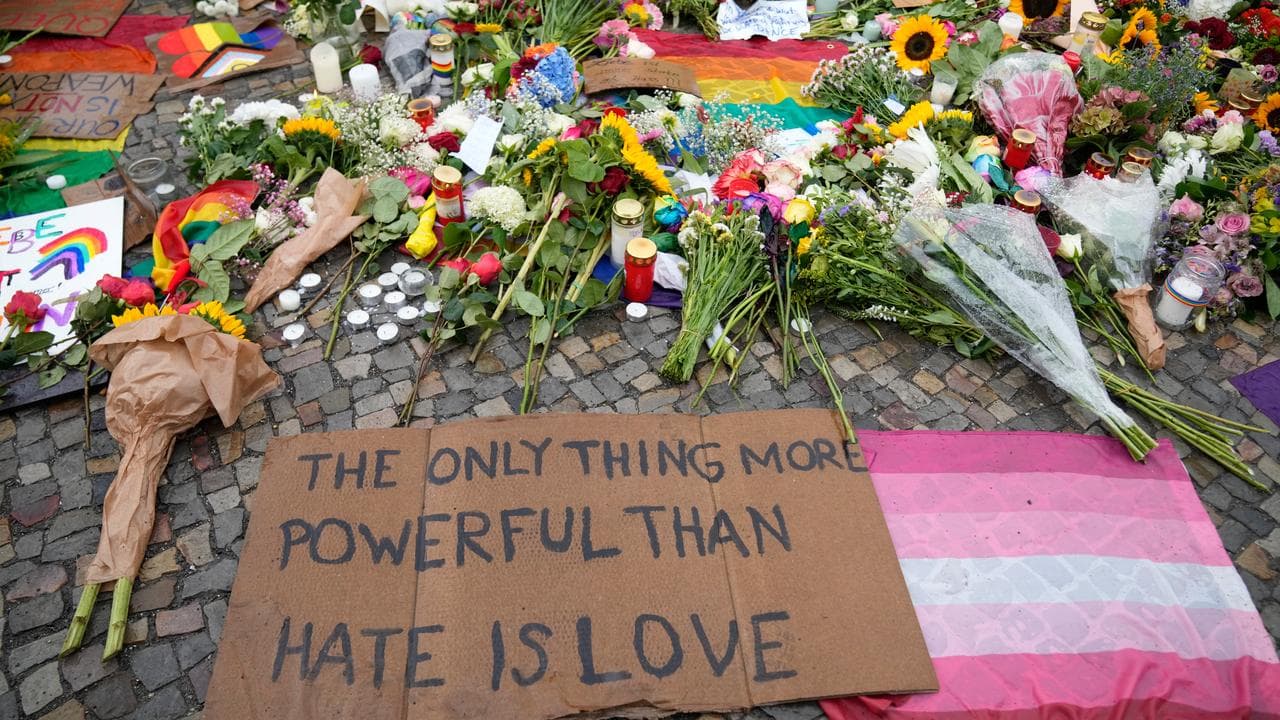People leave flowers and notes outside the Brandenburg Gate