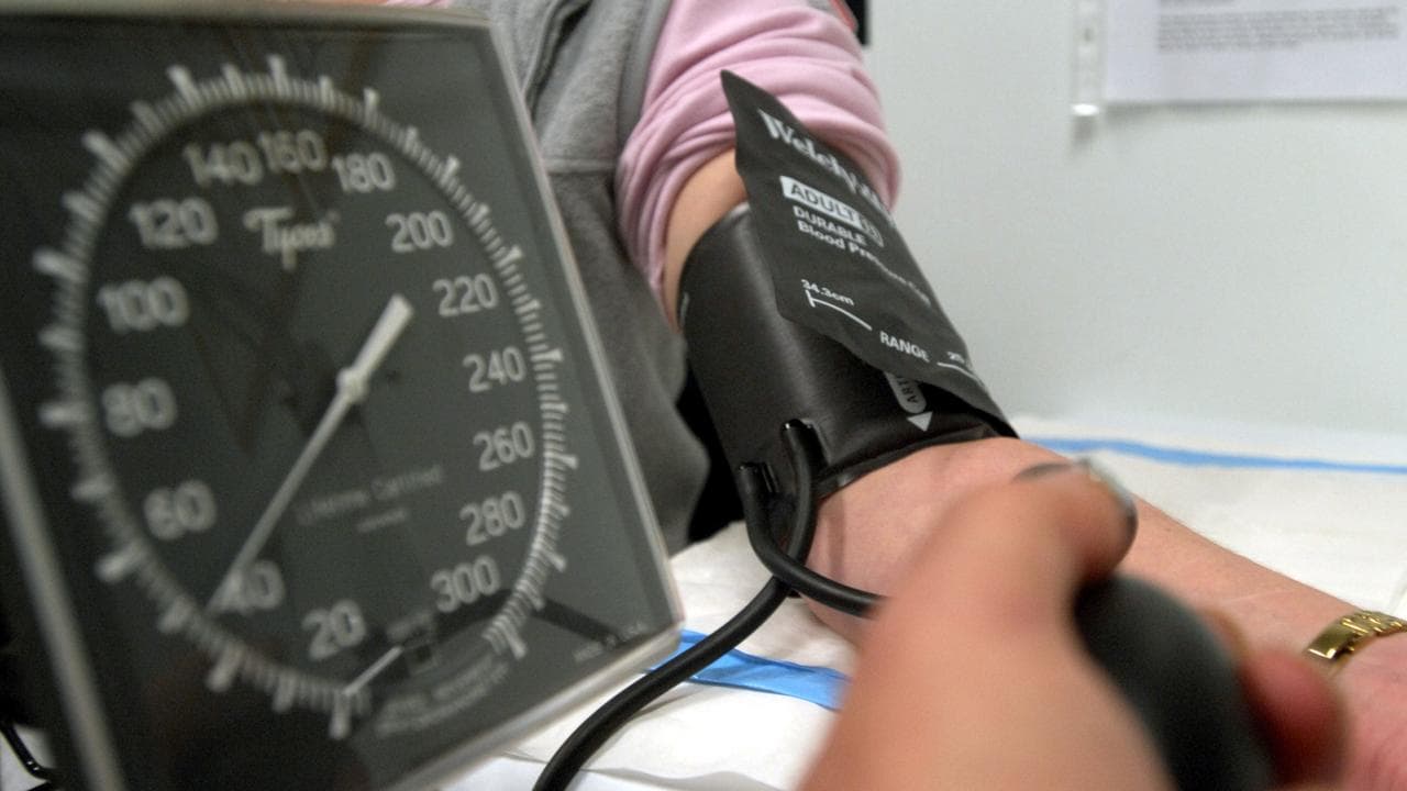 A patient has their blood pressure checked (checked)
