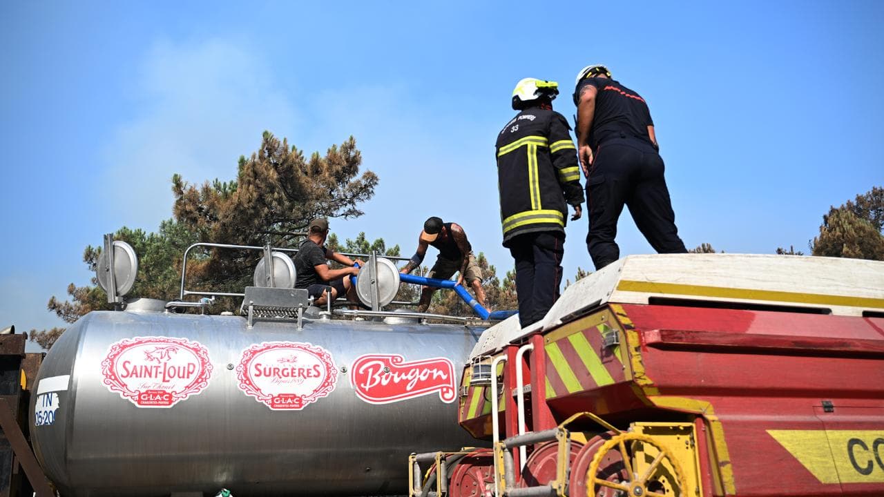 Firefighters fill a tank with water near Claouey, France