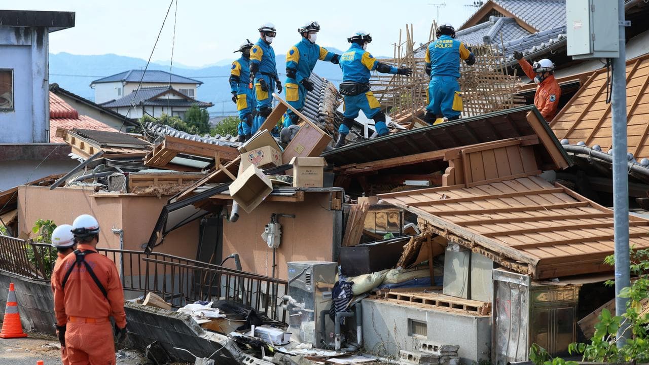 Rescue operations continue in a collapsed house in Yatsushiro city