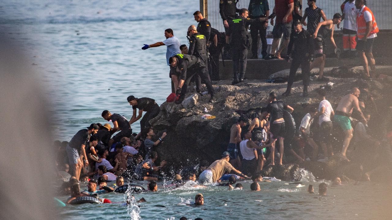 Migrants try to cross from Morocco into the Spanish enclave of Ceuta