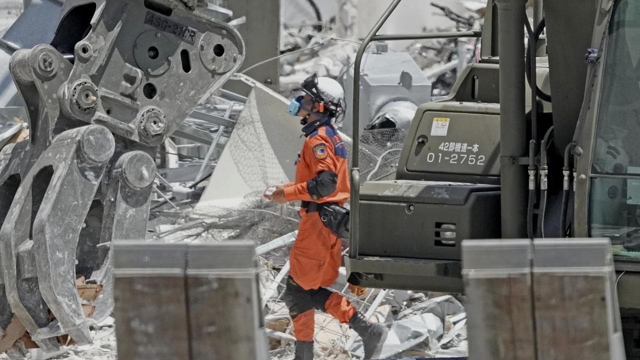 A firefighter searches the damaged AEON Mall in Japan