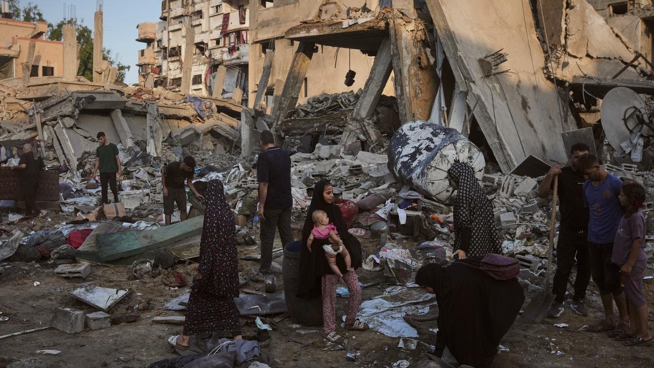 Palestinians salvage their belongings from the rubble in Gaza City 