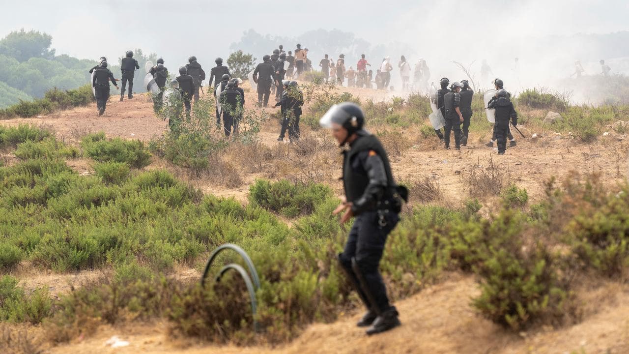 Members of Moroccan security forces disperse people