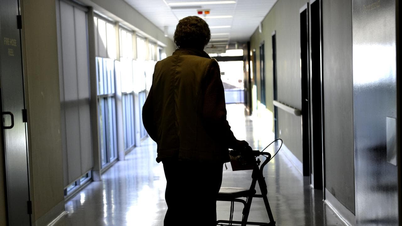 A woman uses a walker to assist her mobility