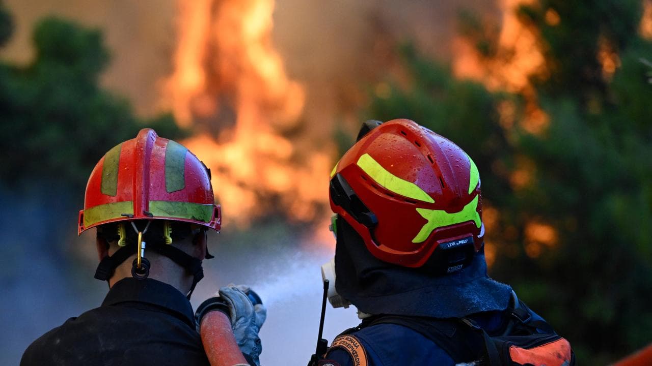 Firefighters operate during a wildfire near Porto