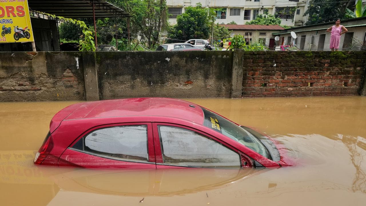 A submerged car on a flooded road after heavy monsoon rain