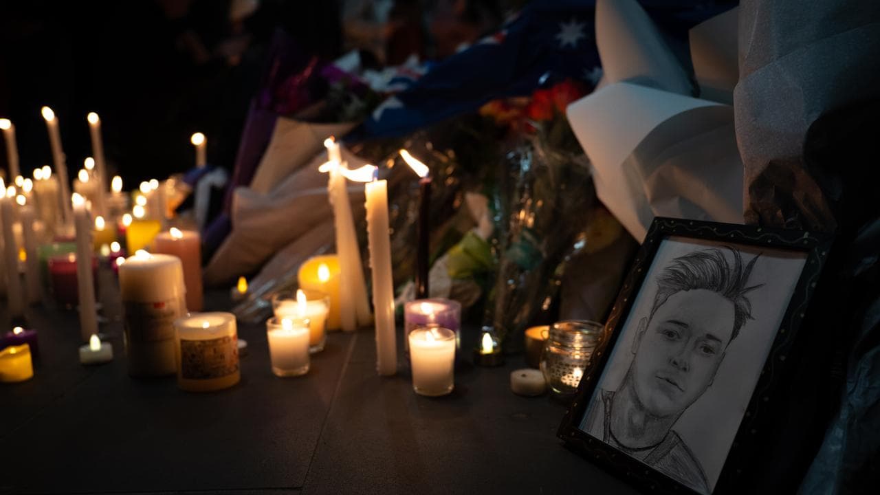 candlelight vigil with sketch of Aidan Becker