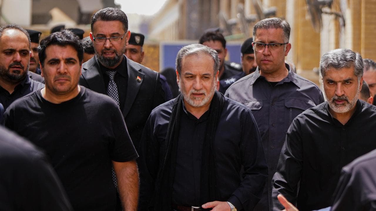 Iran's Foreign Minister Abbas Araghchi, surrounded by security staff