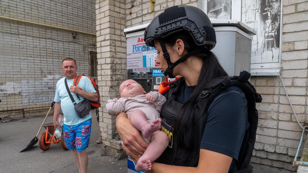 A rescuer holding a baby