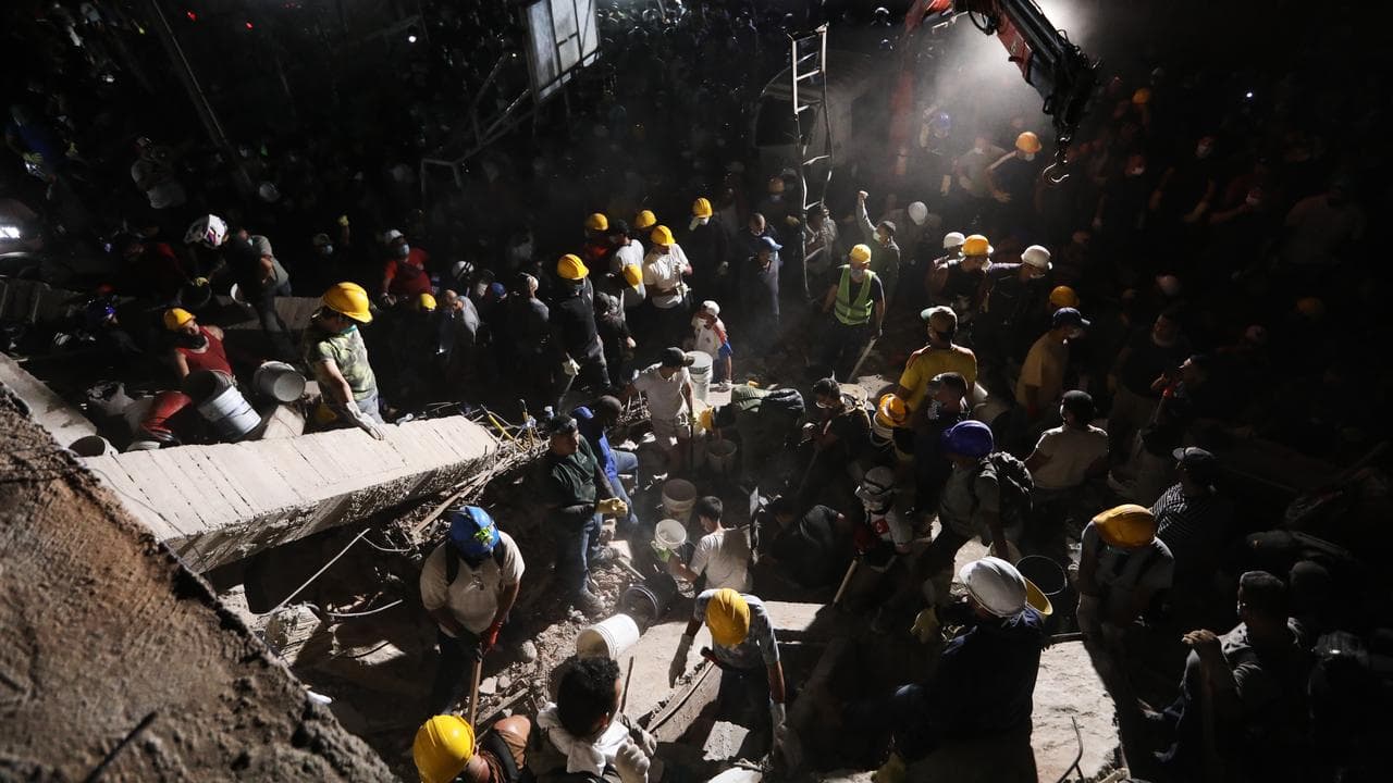 Rescuers search through rubble after an earthquake in Cali, Colombia