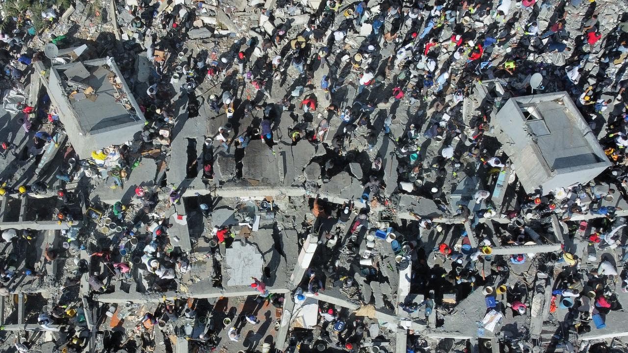 Residents and rescue workers search through the rubble in Cali