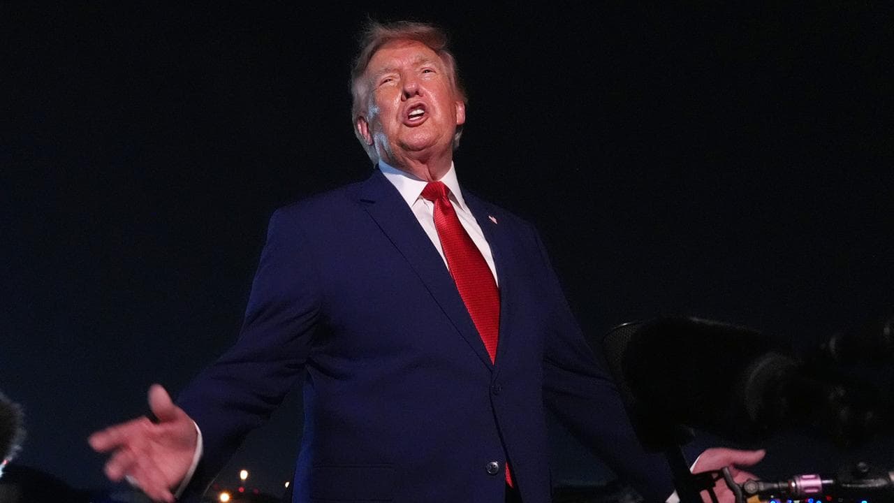 US President Donald Trump talks to reporters outside Air Force One