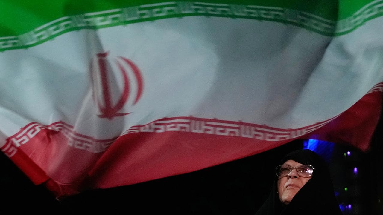 Iranian flag during a pro-government gathering in Tehran, Iran