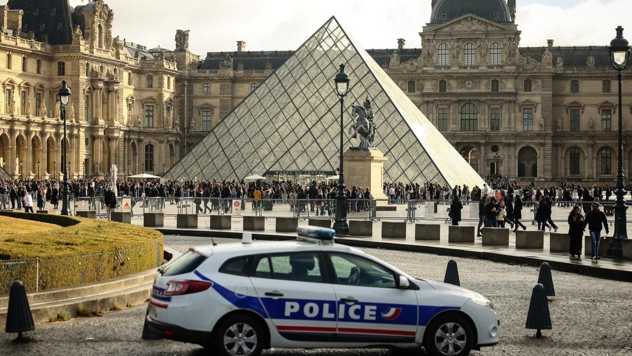 A police car in the courtyard of the Louvre museum
