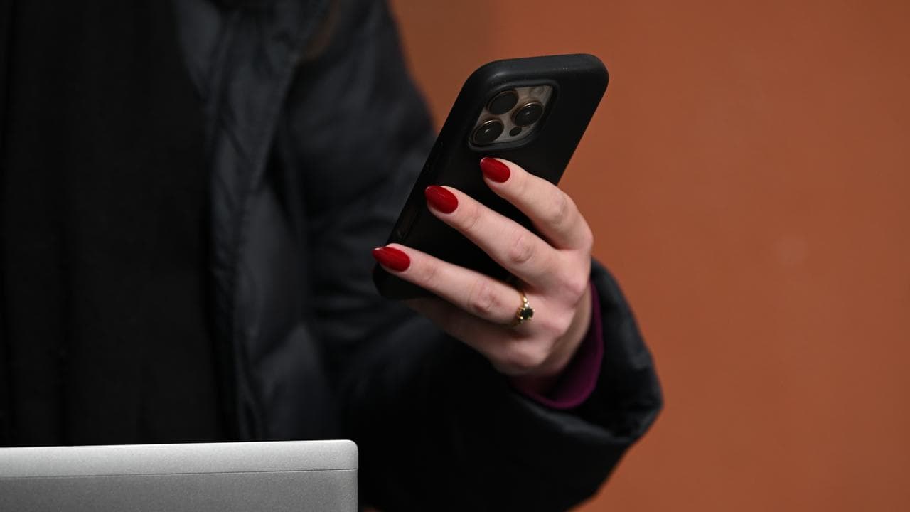 Generic image of a person holding a mobile phone