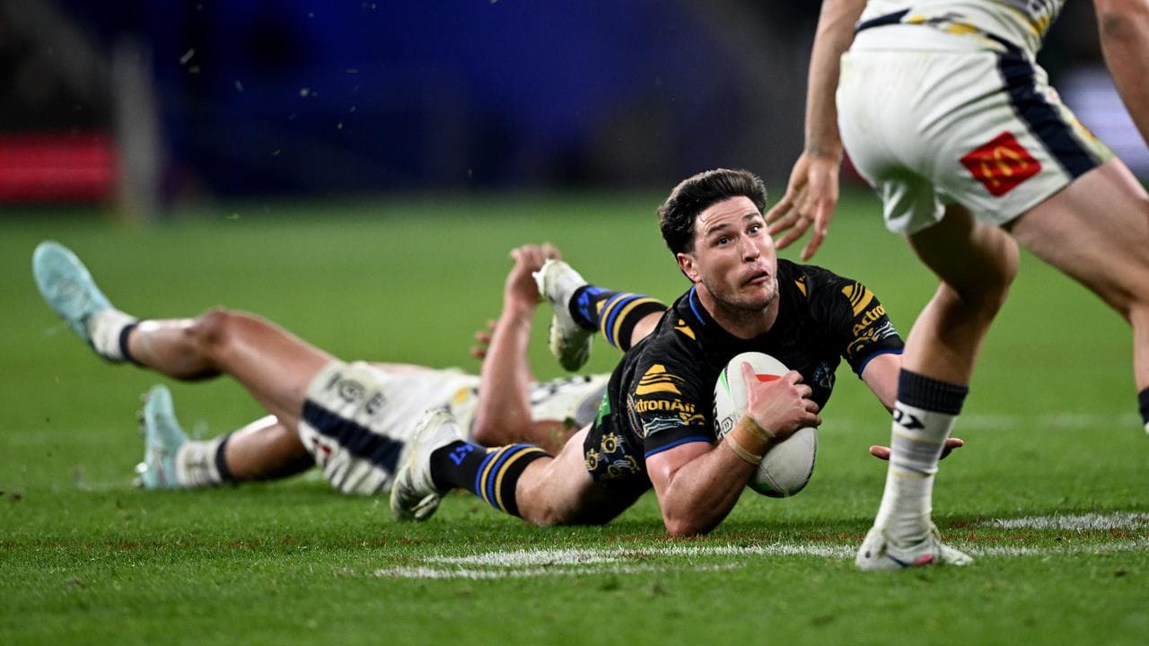 Parramatta's Mitchell Moses is tackled by the Cowboys' Heilum Luki.