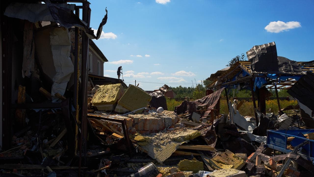 A man clears debris where the three year old died
