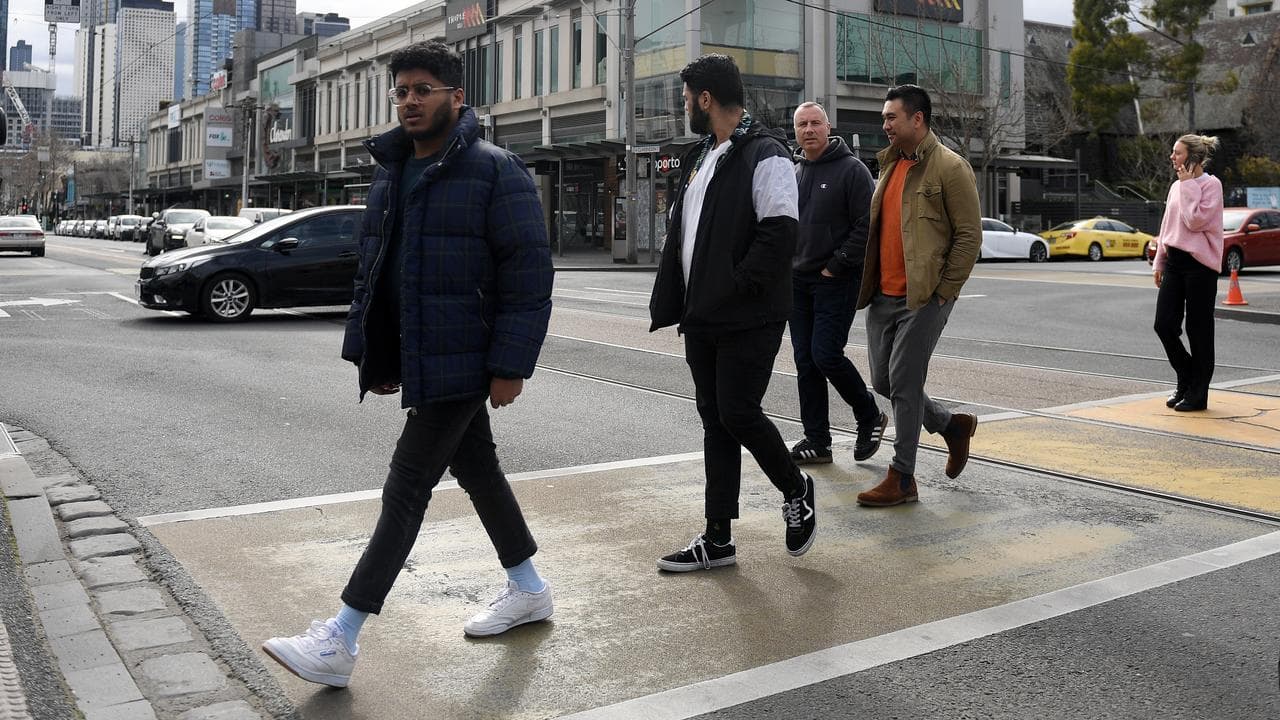Stock image of people in Melbourne crossing the road