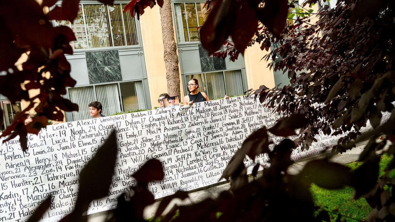 A banner with the names of dead children