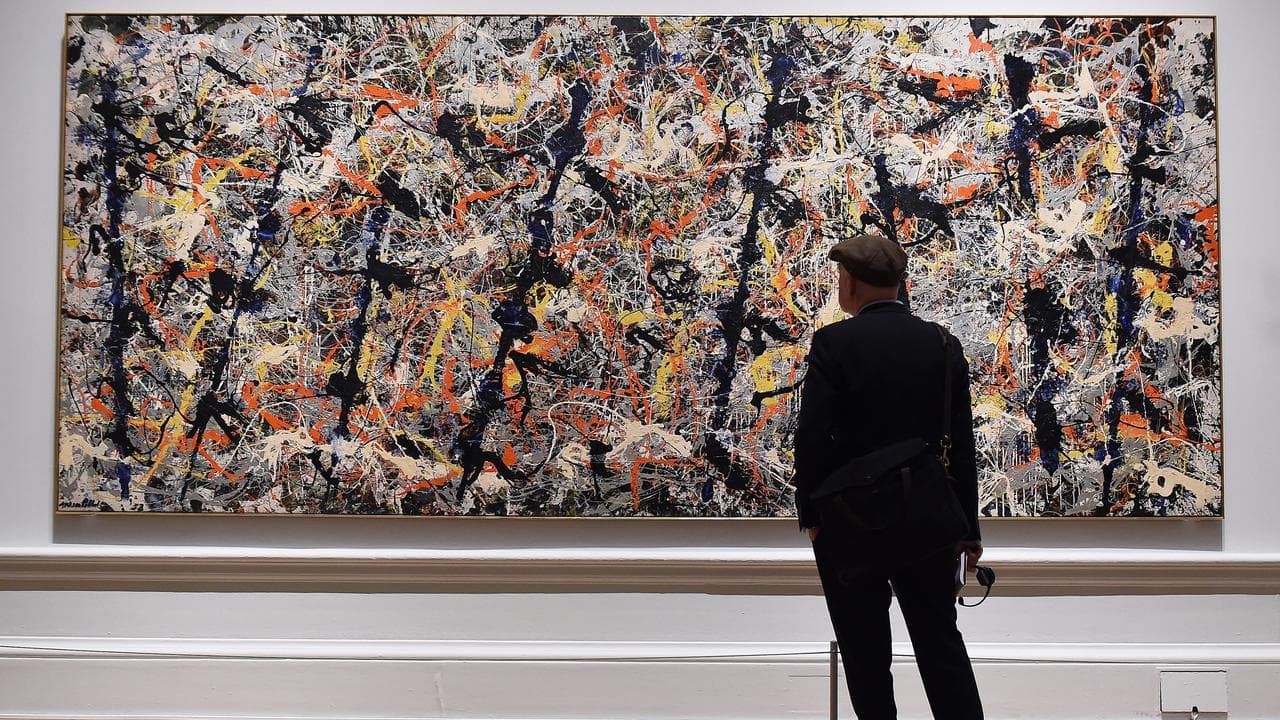 A visitor looks at Blue Poles